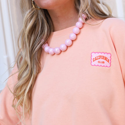 California sweater oranje